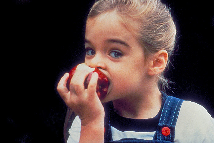 child eating apple